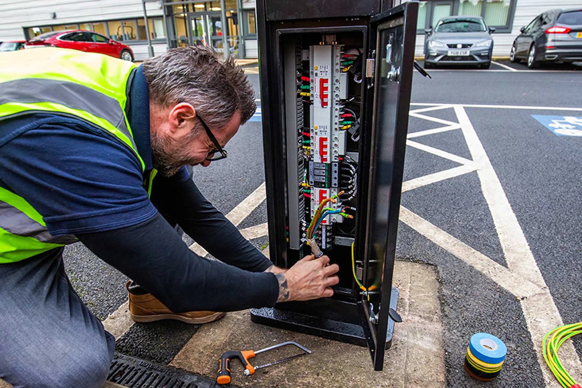 An EV engineer, installing an EV charger